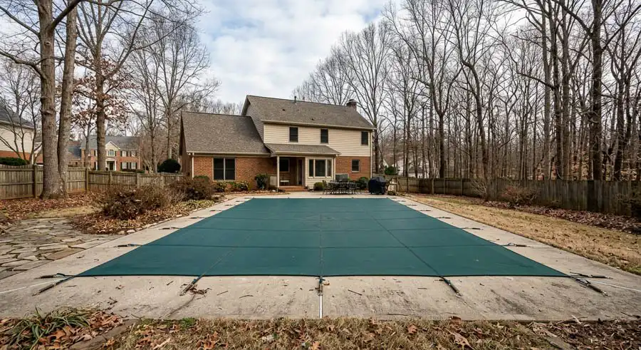 Winterized pool with a secure safety cover in Huntersville NC.